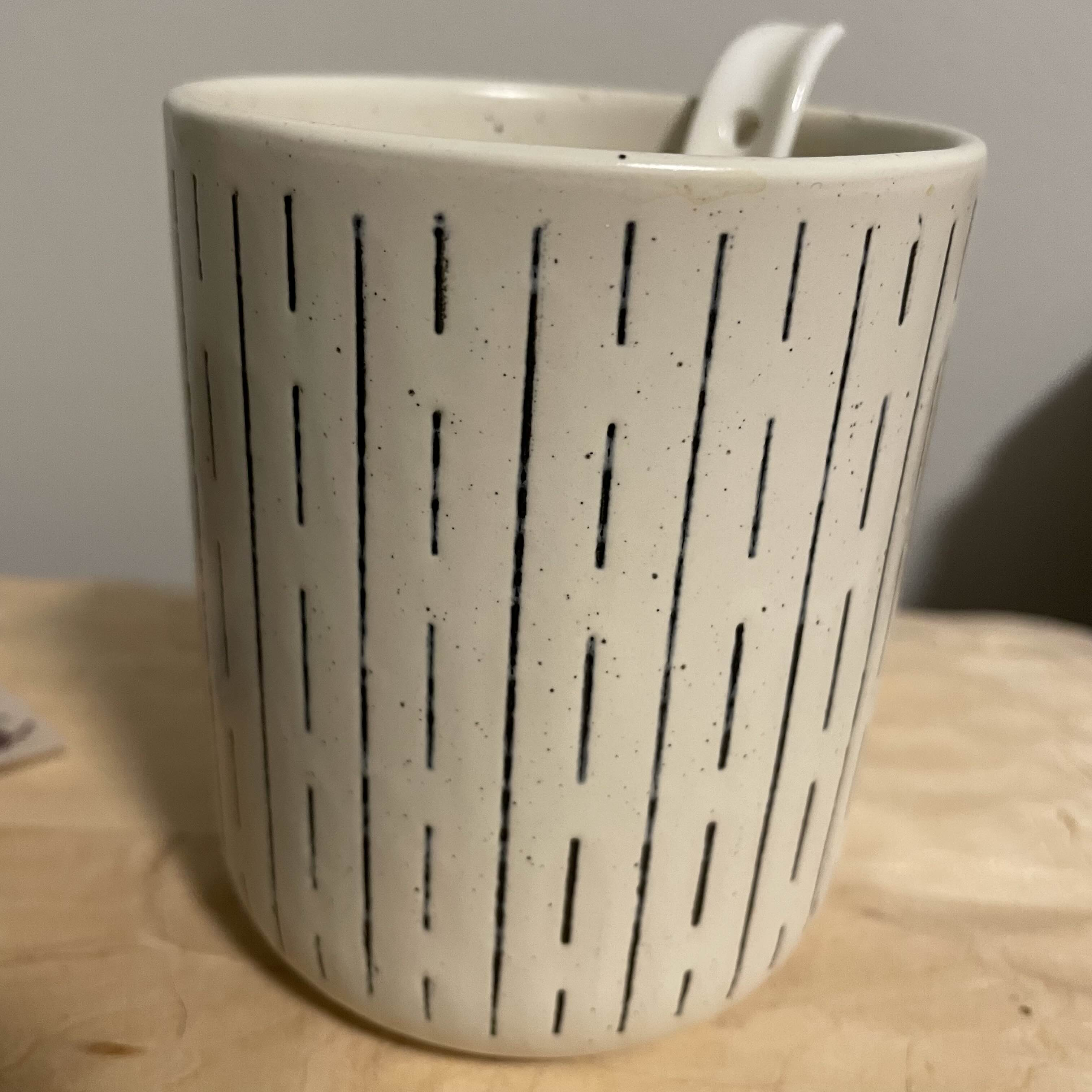 A ceramic cup and spoon